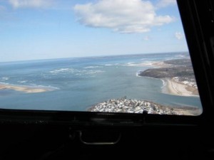The mouth of the Ipswich River from 1000 feet framed in a helicopter door: Little Neck is below.  Castle Hill and Crane Beach are off to right, and the south tip of Plum Island is across the sound to left.  The Atlantic feeds and takes from estuarine marshes twice daily. -  Stream Team photo